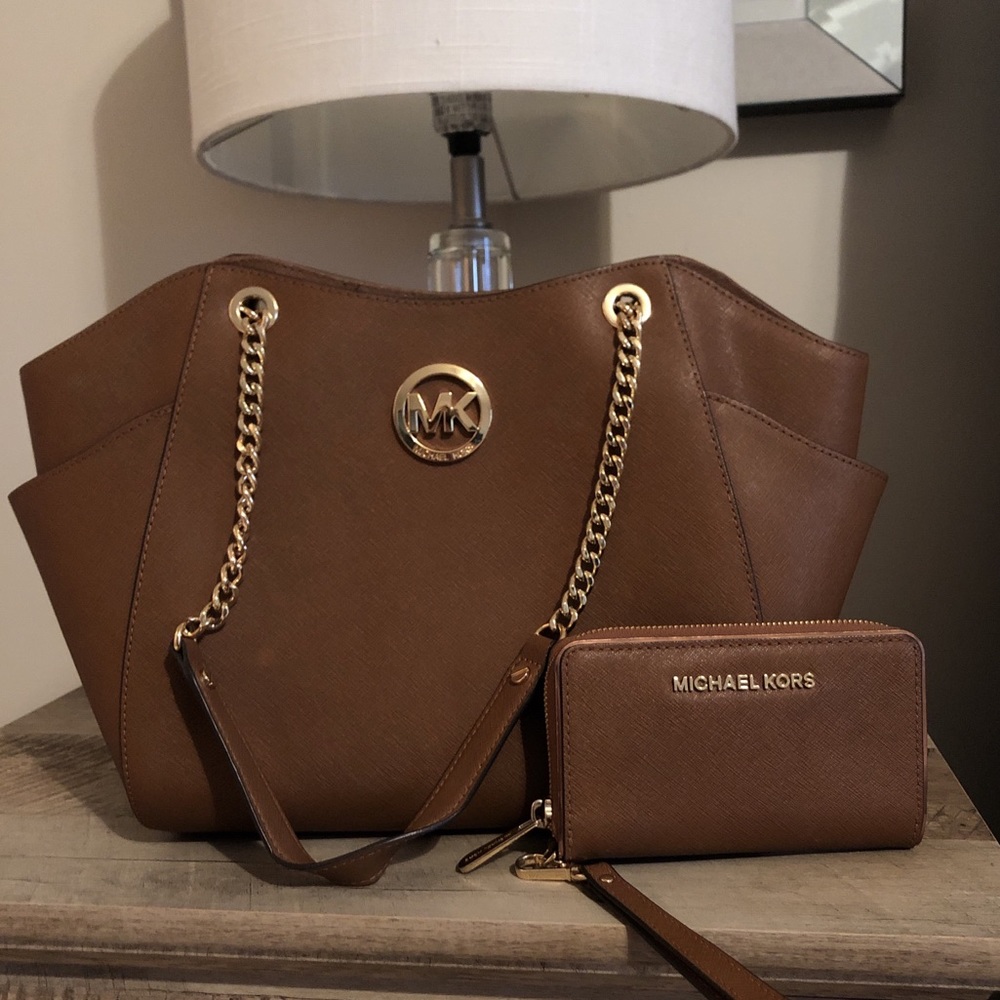 Brand new Michael Kors purse with matching wallet.